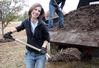 Laura Axelson, freshman elementary eduaction major, shovels mulch at Liberty Garden Park during Campus and Community Day.  - Photo by Ebbie Davis