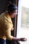 Glenae Nora, sophomore history major, cleans a window at the Neil House, an 1800s home that has been relocated to Casey Jones Village. The history department helped in the restoration of this home as a part of Campus and Community day.  - Photo by Kristi McMurry