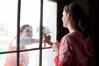 Junior history majors Caitlin Roach and Savannah German clean a window at the Neil House, an 1800s home that has been relocated to Casey Jones Village. The history department helped in the restoration of this historic home as part of Campus and Community Day.  - Photo by Kristi McMurry