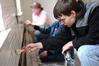 Michael Jones, freshman chemistry major, helps paint an old church as part of the history department's Campus and Community Day project.  - Photo by Kristi McMurry
