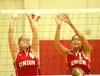Seniors Lindsay Stahlberg (4) and Crystal Abel (12) attempt to block a shot. - Photo by Steven Aldridge