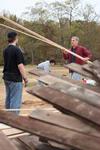 David Thomas, professor of history, works with students to move lumber at the Neil House, a historic home being restored at Casey Jones Village. The history department helped with the restoration as a part of Campus and Community Day. - Photo by Kristi McMurry