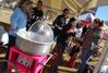 Cotton candy was a popular treat for the kids during the Homecoming festivities. Dr. Taylor Worley, associate dean for spiritual life, and his wife Anna, research assistant to the VP for student services, talk with students as their children eat the cotton candy. - Photo by Abigail Harris