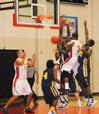 CJ Davis fights through his Truett-McConnell College opponents for a shot during the homecoming game.  - Photo by Victoria Stargel