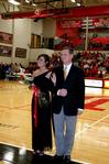 Kari Beougher, senior social work major, waves as she is escorted for the homecoming court during halftime of the Lady Bulldogs basketball game.  - Photo by Deanna Santangelo