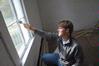 Cale Little, sophomore history major, helps paint the trim on a window of an historic church located in Casey Jones Village. The history department helped with restoring two buildings as a part of Campus and Community Day.  - Photo by Morris Abernathy