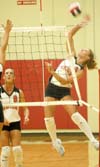 Freshman Kelly Huffines (9) reaches way back for a kill attempt.  Jenney Glassey (8) looks on. - Photo by Steven Aldridge
