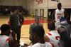 David Niven, head men's basketball coach, goes over a play during a time-out.  - Photo by Ebbie Davis