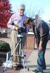 Bill Nettles, professor of physics and department chair, shows Ben Haws, sophomore media communications major, how to look at sunspots through a solar telescope. - Photo by Victoria Stargel