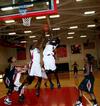 Beatrice Awino Duola and Zeinab Chan jump up for a rebound after a free-throw during a game against Azusa Pacific University during the second round of the 17th Annual Jackson Rotary Classic. - Photo by Deanna Santangelo