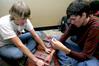 Andrew DiBenedetto, sophomore biology major, and Michael O'Malley, junior English major, wrap a book for an 11 year old girl for the Carl Perkins Christmas Party. - Photo by Deanna Santangelo