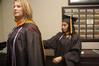 Michelle Edacherit helps Crystal Lofton, both receiving their master of science in nursing, prepare for graduation. - Photo by Beth Spain