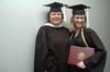 Ashley Blair, assistant professor of communication arts, and Union graduate Rachael Kapavik pose together after the December graduation ceremony. - Photo by Beth Spain