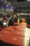 Tim Smith, dean of the school of nursing, calls the names of December nursing graduates as David S. Dockery, president of the university, hands the graduates their diplomas.  - Photo by Morris Abernathy
