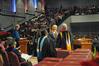 David S. Dockery, president of the university, hands graduates their diplomas as Tim Smith, dean of the school of nursing, calls out the names of December nursing graduates.  - Photo by Morris Abernathy