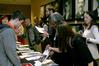 Patricia Porter, transfer enrollment counselor, and Sarah Brooks, enrollment counselor, explain the welcome packet to prospective students during a winter preview day. - Photo by Deanna Santangelo