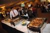 Guests of the 4th Annual Black History Month Program go through the dinner line before hearing Renita J. Weems speak. - Photo by Morris Abernathy