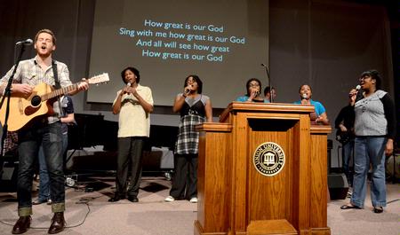 A group of students leads music at the beginning of chapel.
