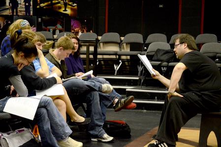 Kevin Anderton, visiting director, discusses the script for the upcoming play, "The Winter's Tale," with the actors. The show will run March 10-15.