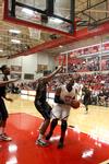 Shane Burrell goes up for a shot against Bethel University defenders. The Bulldogs won the game 77-75. - Photo by Ebbie Davis