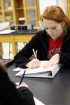 Whitney Baker, junior elementary education major, takes notes in her physics class.  - Photo by Kristi McMurry
