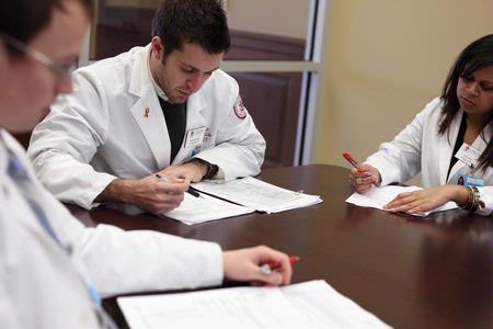 Pharmacy students go over their patient notes during class. 