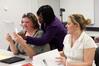 Rhonda Hudson, associate professor of social work and director of BSW adult studies program, hands back papers to students before class.  - Photo by Kristi McMurry