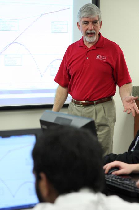 Bill Nettles, professor of physics and department chair, teaches a class in the new physics lab.