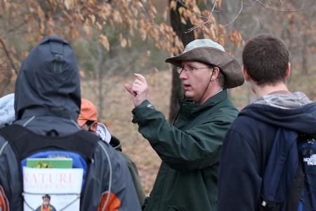 Andy Madison, associate professor of biology, talks to his conservation biology students during a field trip to the West TN Research & Education Center.