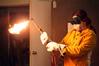 Haelim Allen, assistant professor of art, demonstrates how to operate the cutting torch in her sculpture class.  - Photo by Kristi McMurry