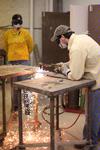 Casey Williams, junior art major, follows instruction from Haelim Allen (left), assistant professor of art, on how to use the cutting torch in sculpture class. - Photo by Kristi McMurry