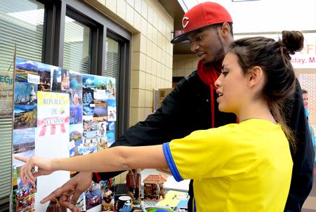 Claudia Velasco, sophomore accounting major, talks about the different scenes that can be found in the Republic of Ecuador to Antoine Hall, freshman computer science major, during the CultureFest 2011 culture fair in the Student Union Building.