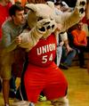 Chase Tuggle, sophomore youth ministry major, joins Buster the Bulldog in cheering for the Lady Bulldogs in a game against Bethel University.  - Photo by Ebbie Davis