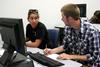 Jenna Cherry, junior elementary education major, and David Leisey, sophomore elementary education major, talk about an assignment during instructional technology in the classroom. - Photo by Deanna Santangelo