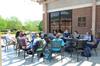 On beautiful days at Union, many teachers bring their classes outside, like this literature class meeting in the shade of the Barefoots Joe patio. - Photo by Beth Spain