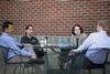Jay Bernheisel, associate professor of engineering, Fonsie Guilaran, associate professor of physics, Jennifer Gruenke, associate professor of biology, and Geoffrey Poore, assistant professor of physics, have a discussion outside of Barefoots Joe on a nice day.  - Photo by Kristi McMurry