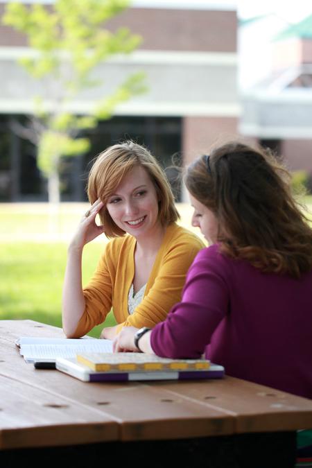 Margaret Brinson, senior journalism major, and Kelsey Nagy, senior art major, study outside for a French exam. 