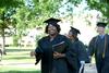 Dionna Conner-Jones, organizational leadership graduate, walks towards the Great Lawn for spring graduation. - Photo by Deanna Santangelo