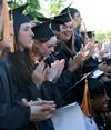 Nursing graduates applaud during spring graduation. - Photo by Deanna Santangelo