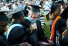 Doctor of Education graduates, Momodou Keita and Mary Alice Marable congratulate each other on receiving their degrees during spring graduation. - Photo by Deanna Santangelo
