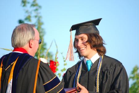 Micah Roeder, business administration graduate, receives his degree at spring graduation.