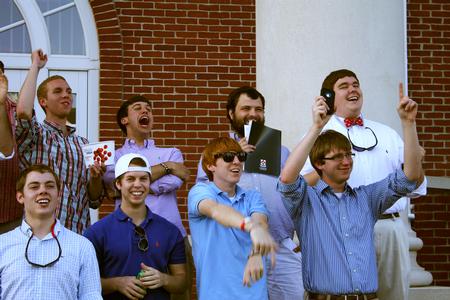 The gentlemen of ATO cheer on their graduating brothers.