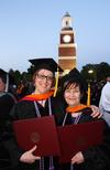 Doctor of nursing practice graduates Patricia Bird and Cynthia Snyder celebrate receiving their diplomas on Union University's Great Lawn. - Photo by Zac Calvert