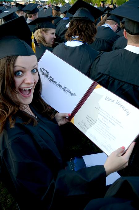 Jessica Davenport, elementary education and learning foundations graduate, poses with her diploma at spring graduation.