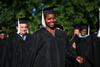 Randall Emmalee Simpson, English graduate, walks to the Great Lawn for spring graduation. - Photo by Kristi McMurry