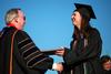 Katie Mohler, history graduate, receives her degree at spring graduation. - Photo by Kristi McMurry