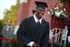 Antoine Joseph, sports management graduate, leaves the stage after receiving his degree at spring graduation. - Photo by Kristi McMurry
