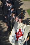 Emily Alm, French and TESL graduate, Brandy Beilke, Spanish graduate, and the rest of the spring graduates follow senior class president Betsy Davis to the Great Lawn.  - Photo by Morris Abernathy