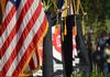 The flag of the United States and Union Banners in front of the stage during spring graduation. - Photo by Morris Abernathy