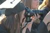 Angela Abbamonte, journalism graduate, pulls out her camera to capture some of the moments during spring graduation. - Photo by Morris Abernathy